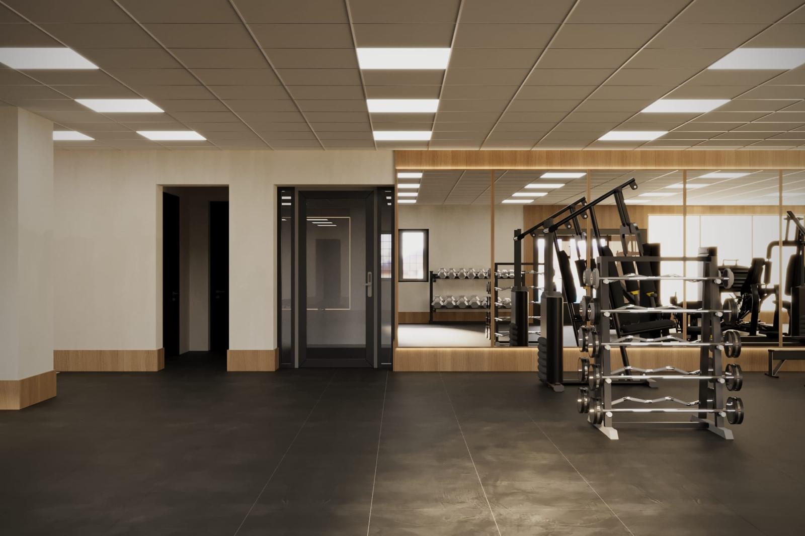 The Cwrtium training floor with oak-lined mirror walls and a barbell rack